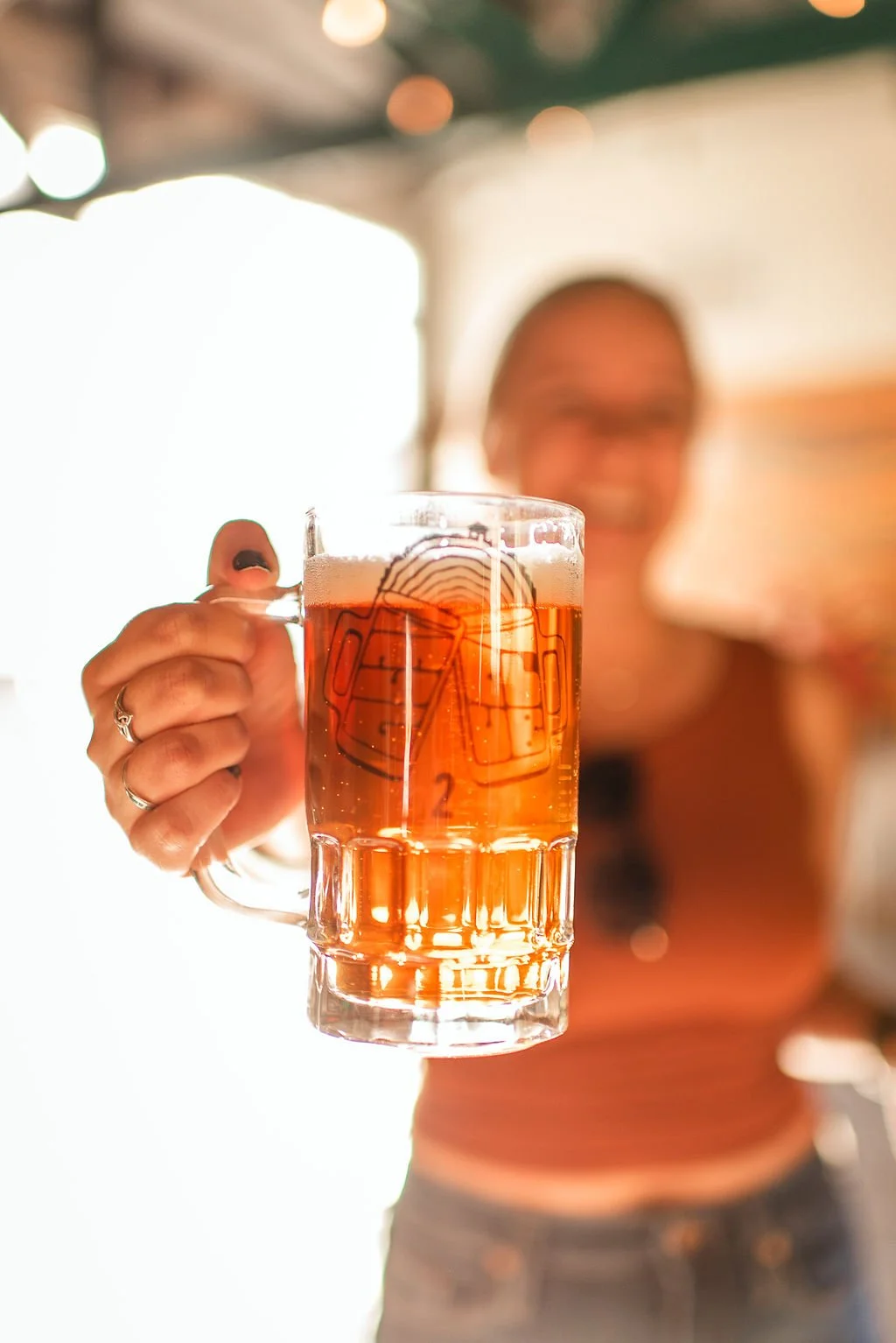 A pint of beer with the Grove House logo etched into the glass